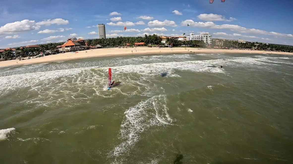 Aerial view of Mui Ne beach with kitesurfers on the water